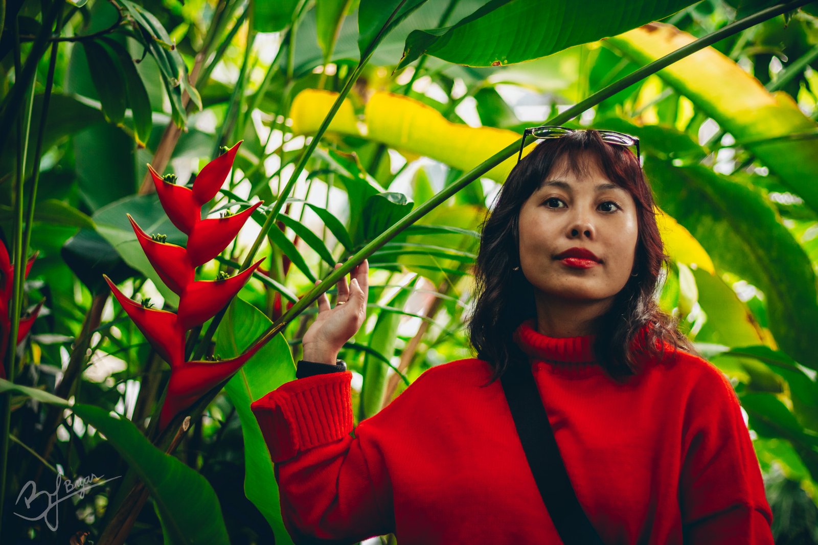 a woman next to Heliconia plant