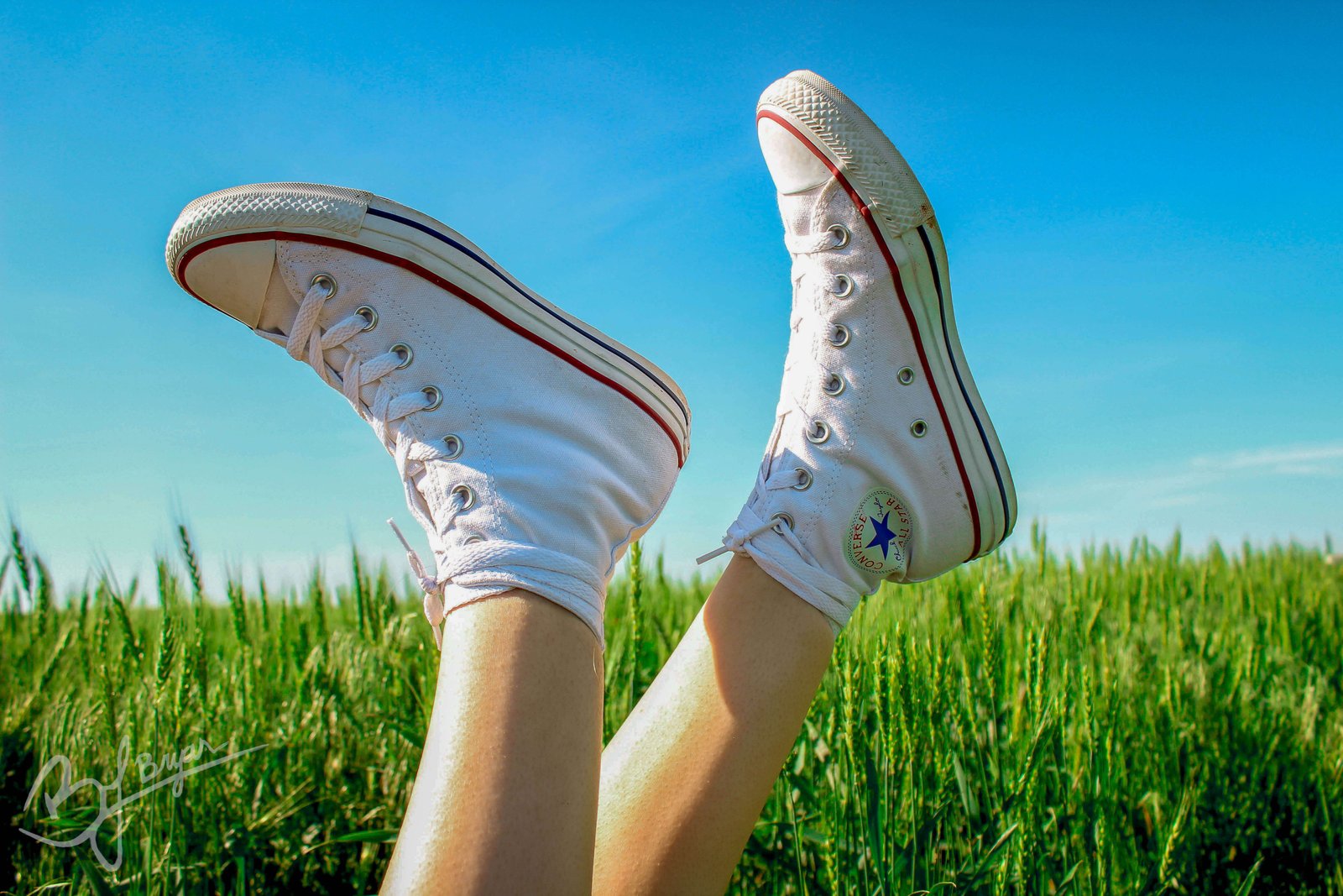 someone's shoes in a field